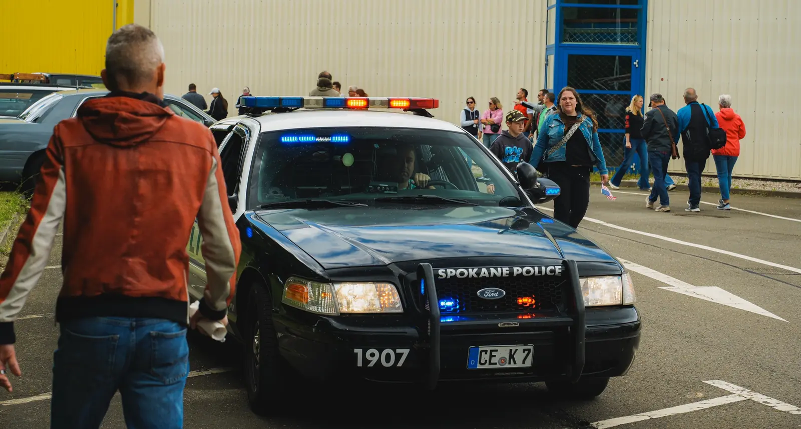 Ford Crown Victoria als Polizeiwagen mit Blaulicht vor vielen Besuchern