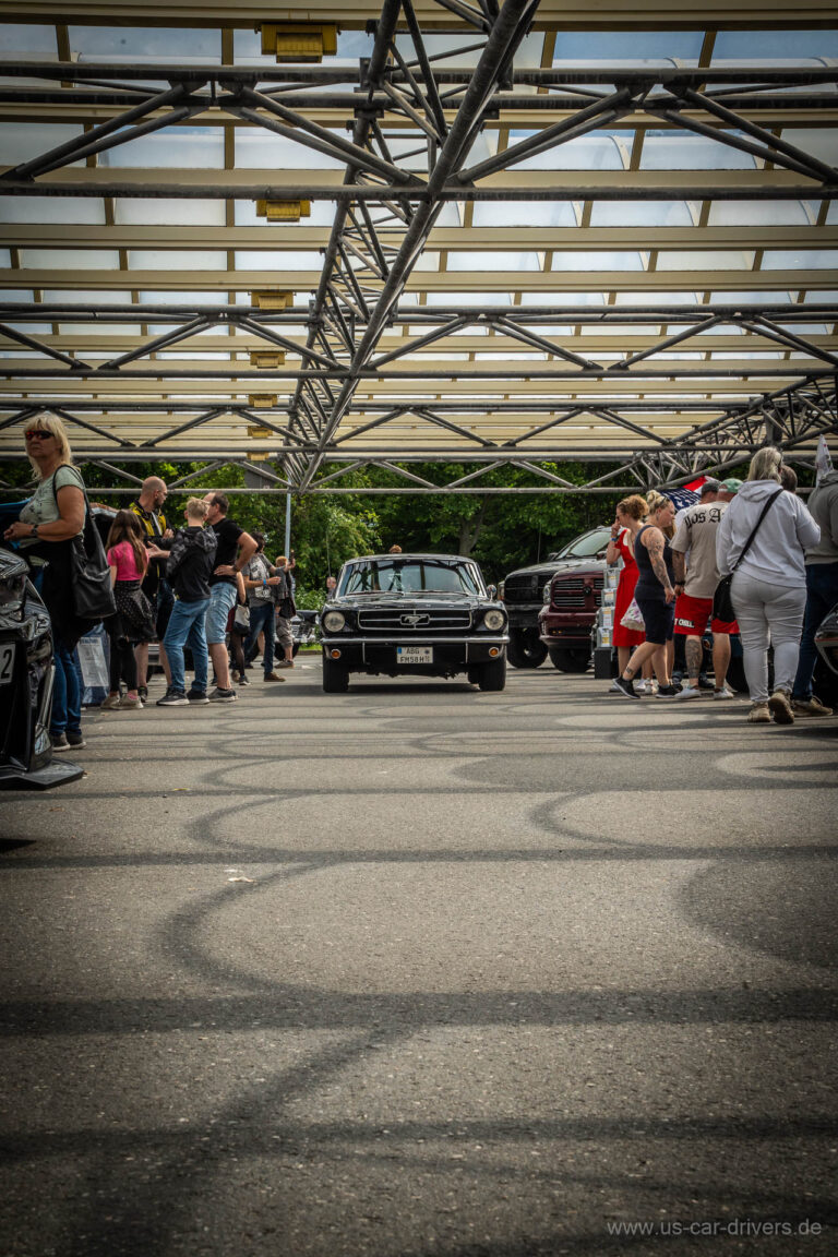 Besucher laufen über den Platz unter dem Hallendach